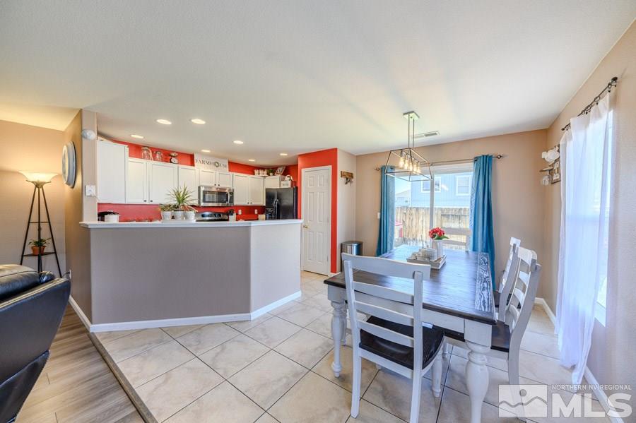 7635 Corso Street Reno, NV 89506 - Photo 5 of 19 a living room with stainless steel appliances kitchen island granite countertop furniture and a dining table