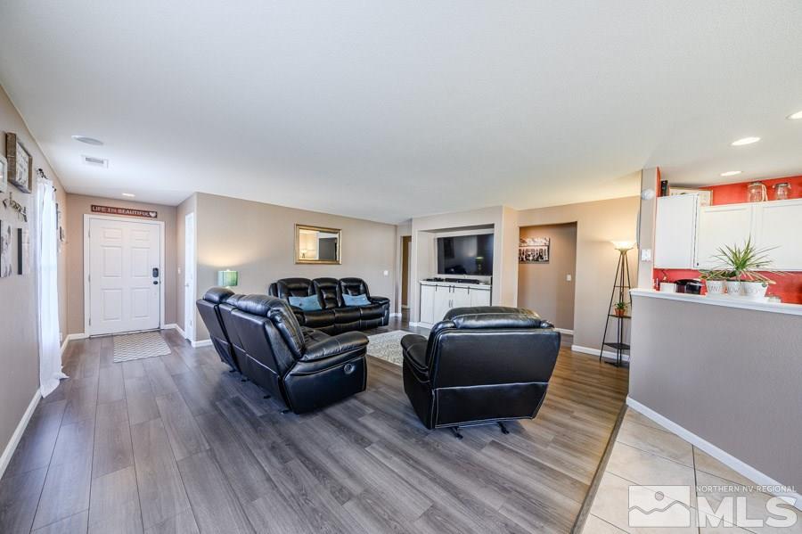 7635 Corso Street Reno, NV 89506 - Photo 7 of 19 a living room with furniture and a wooden floor