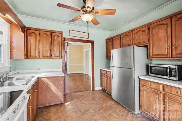 a kitchen with stainless steel appliances granite countertop a refrigerator a sink and dishwasher