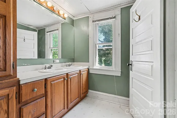 a bathroom with a double vanity sink and mirror
