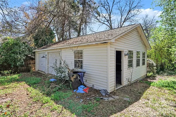 a view of a house with yard and a garden