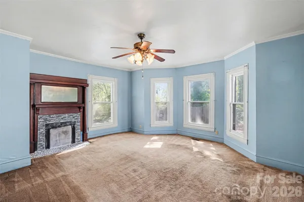 a view of livingroom with fireplace fan and window