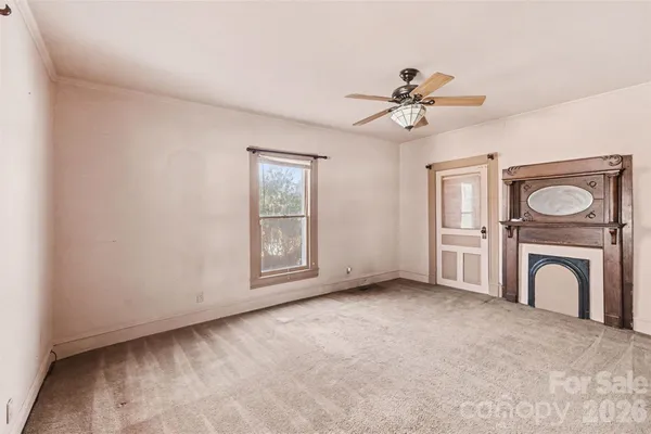 a view of a livingroom with a ceiling fan and a window