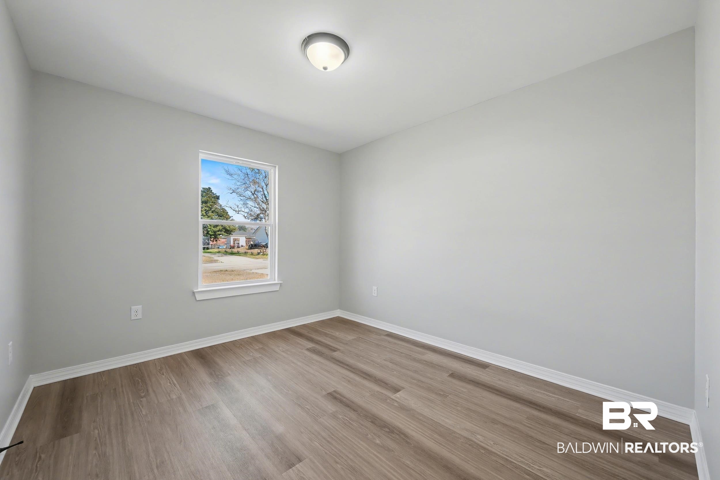 76 Fincher Lane Loxley, AL 36551 - Photo 22 of 33 Unfurnished room featuring baseboards and wood finished floors