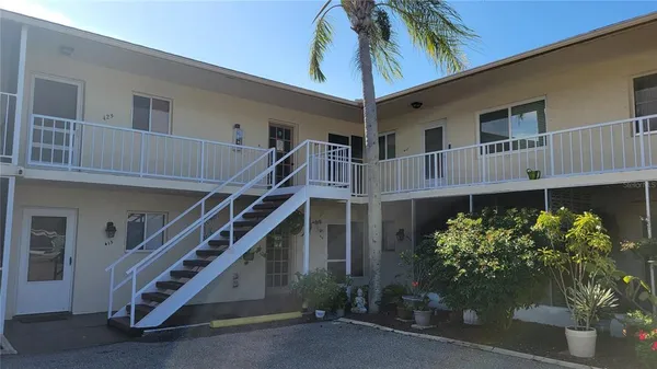 a front view of house along with deck and utility room