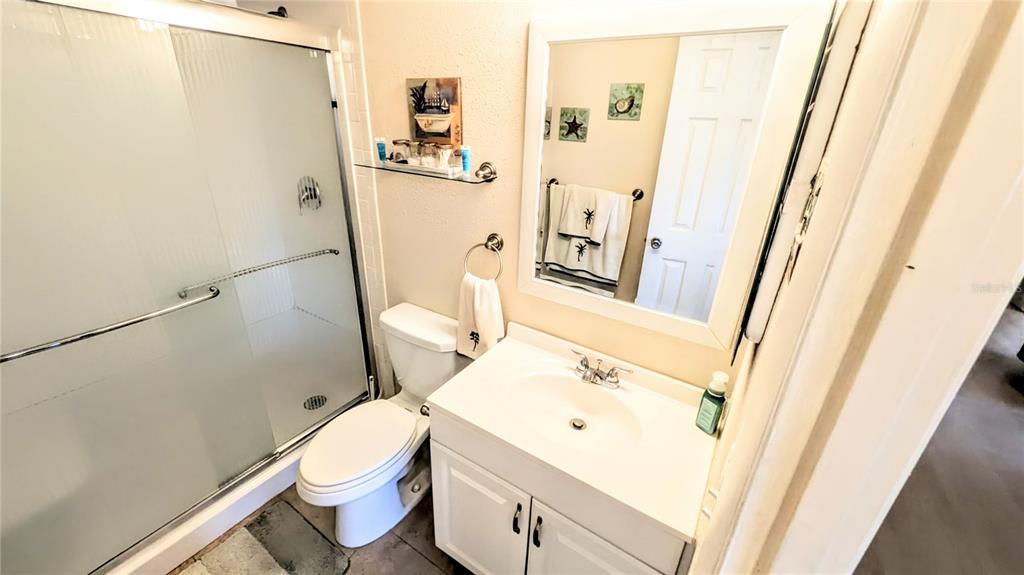 360 Base Avenue East, Unit 424 Venice, FL 34285 - Photo 11 of 20 a bathroom with a sink a toilet and a shower