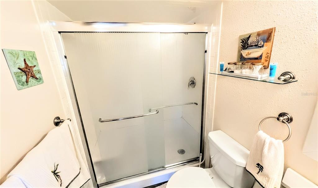 360 Base Avenue East, Unit 424 Venice, FL 34285 - Photo 12 of 20 a bathroom with a shower a toilet and a sink