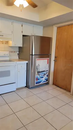 a view of kitchen with stainless steel appliances cabinets and wooden floor