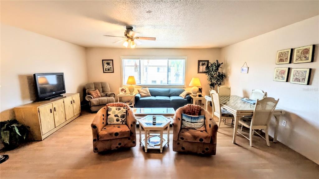 360 Base Avenue East, Unit 424 Venice, FL 34285 - Photo 4 of 20 a living room with furniture and a flat screen tv