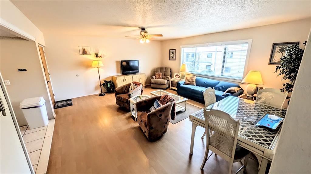 360 Base Avenue East, Unit 424 Venice, FL 34285 - Photo 5 of 20 a living room with furniture and a flat screen tv