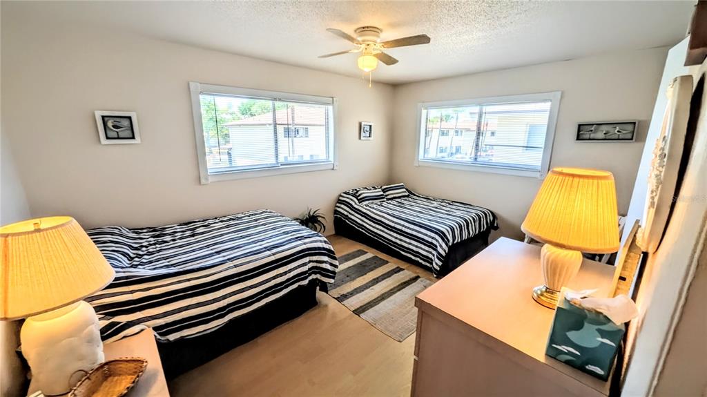 360 Base Avenue East, Unit 424 Venice, FL 34285 - Photo 9 of 20 a bedroom with two beds and a window