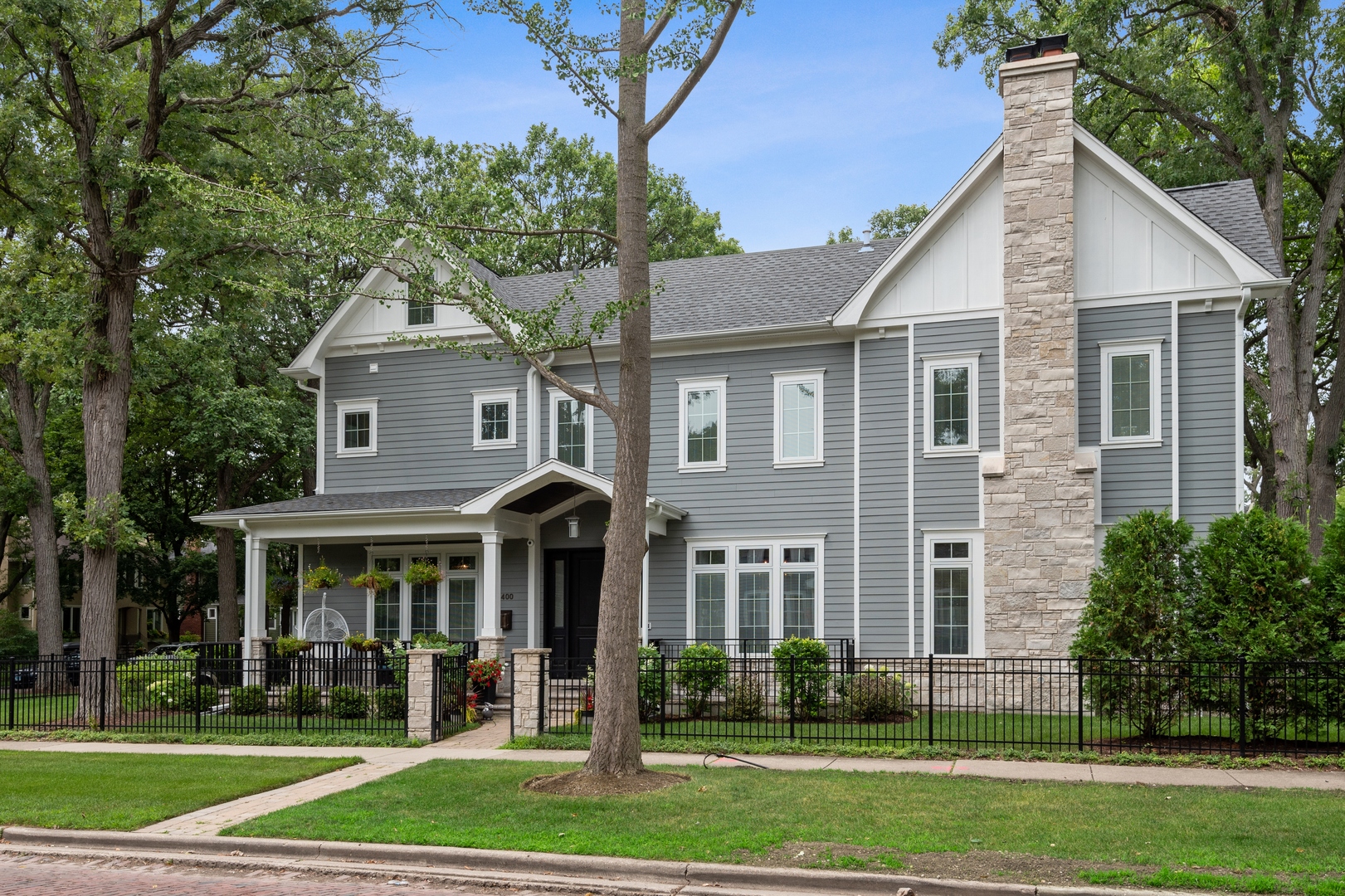 Undisclosed Address Wilmette, IL 60091 - Photo 2 of 66 a view of a yard in front of a brick house