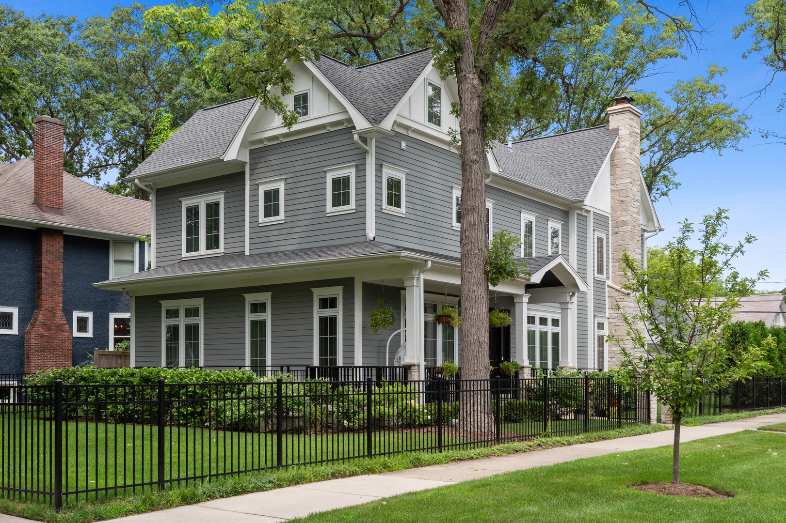 Undisclosed Address Wilmette, IL 60091 - Photo 4 of 66 a view of a white house with a big yard and potted plants