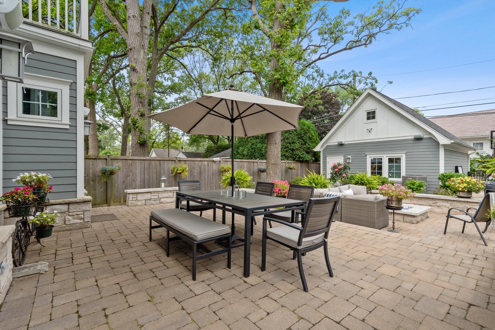 Undisclosed Address Wilmette, IL 60091 - Photo 54 of 66 a view of a patio with a dining table and chairs under an umbrella