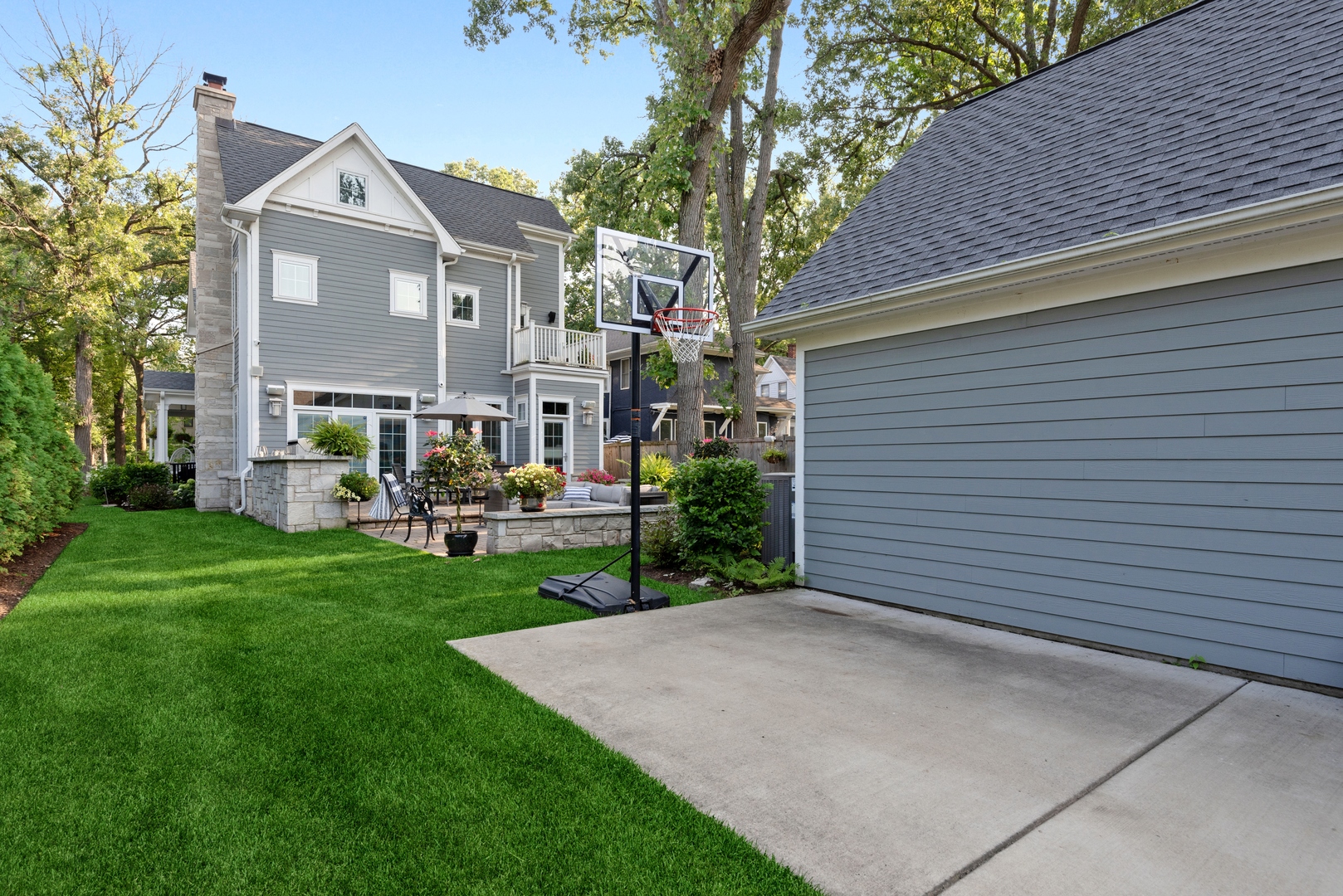 Undisclosed Address Wilmette, IL 60091 - Photo 60 of 66 a view of a white house next to a yard with big trees