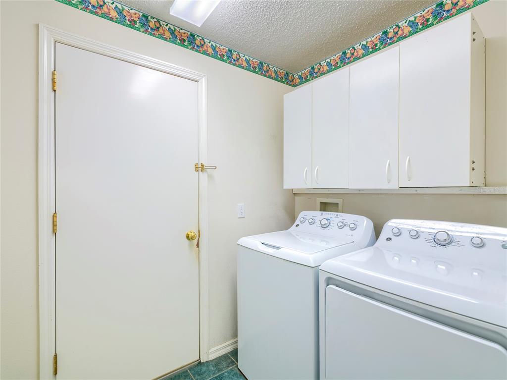 11228 Windrush Circle Hudson, FL 34667 - Photo 13 of 67 a utility room with dryer and washer