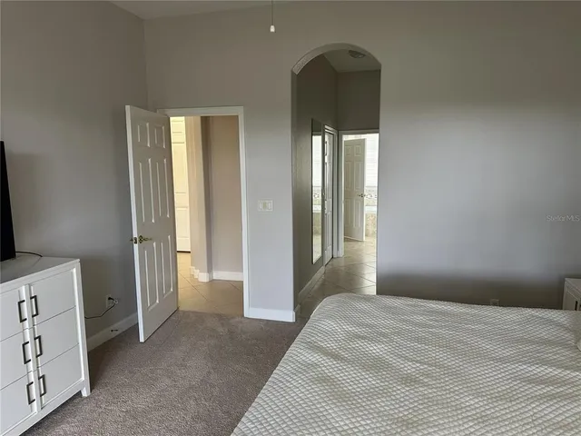 a bedroom with a bed and a dresser