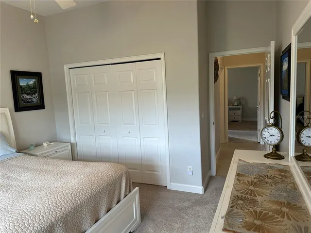 a bedroom with a bed and a mirror