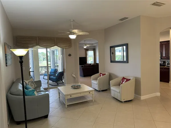 a living room with furniture and chandelier