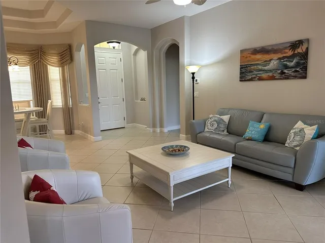 a living room with furniture and a potted plant
