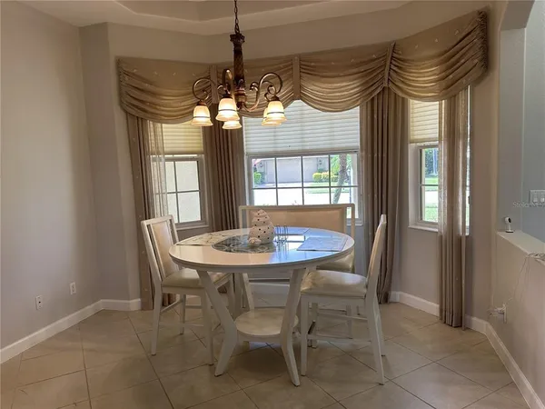 a view of a dining room with furniture and window