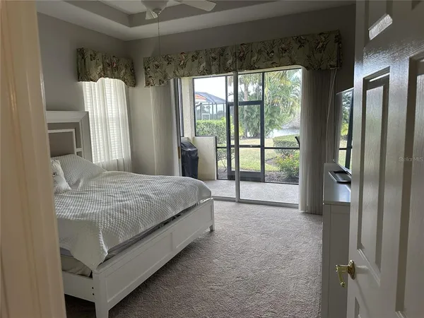 a spacious bedroom with a bed and a large window