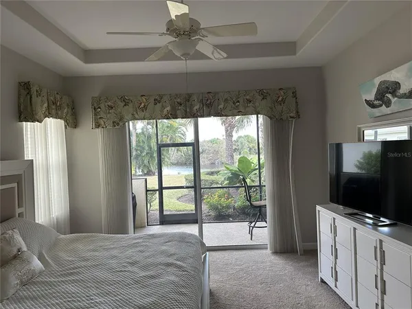 a bedroom with furniture and a flat screen tv