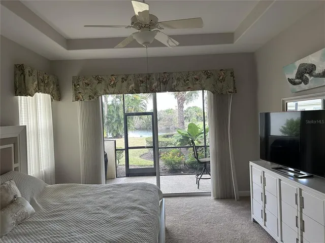 a bedroom with furniture and a flat screen tv
