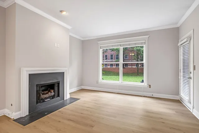 wooden floor fireplace and natural light in room