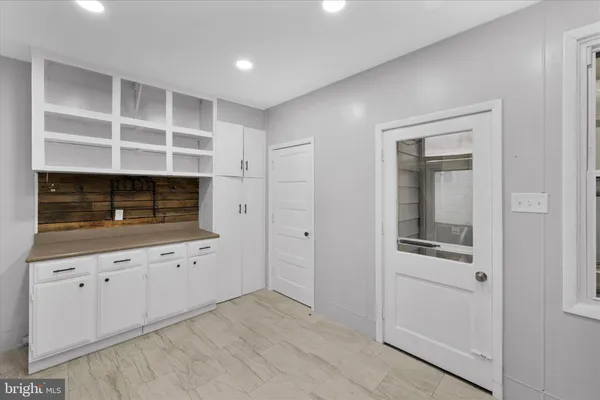 a kitchen with cabinets appliances and a window
