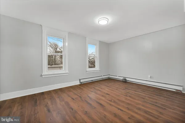 a view of an empty room with wooden floor