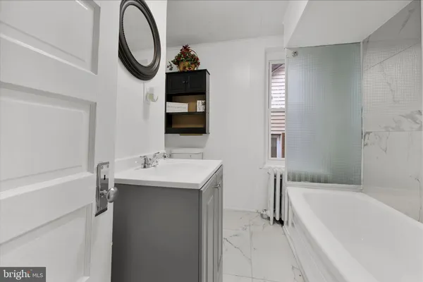 a bathroom with a bathtub and shower