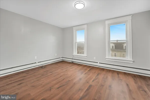 a view of an empty room with wooden floor