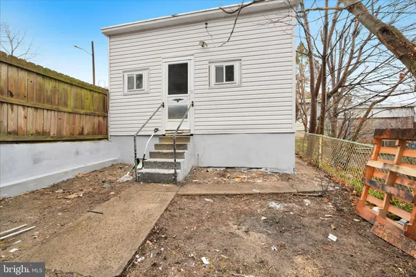 a view of a house with wooden fence