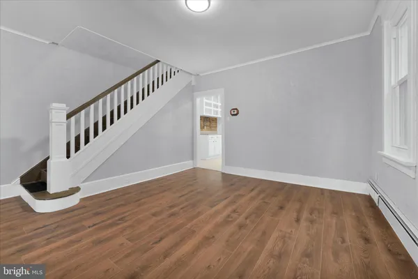 a view of an entryway with wooden floor