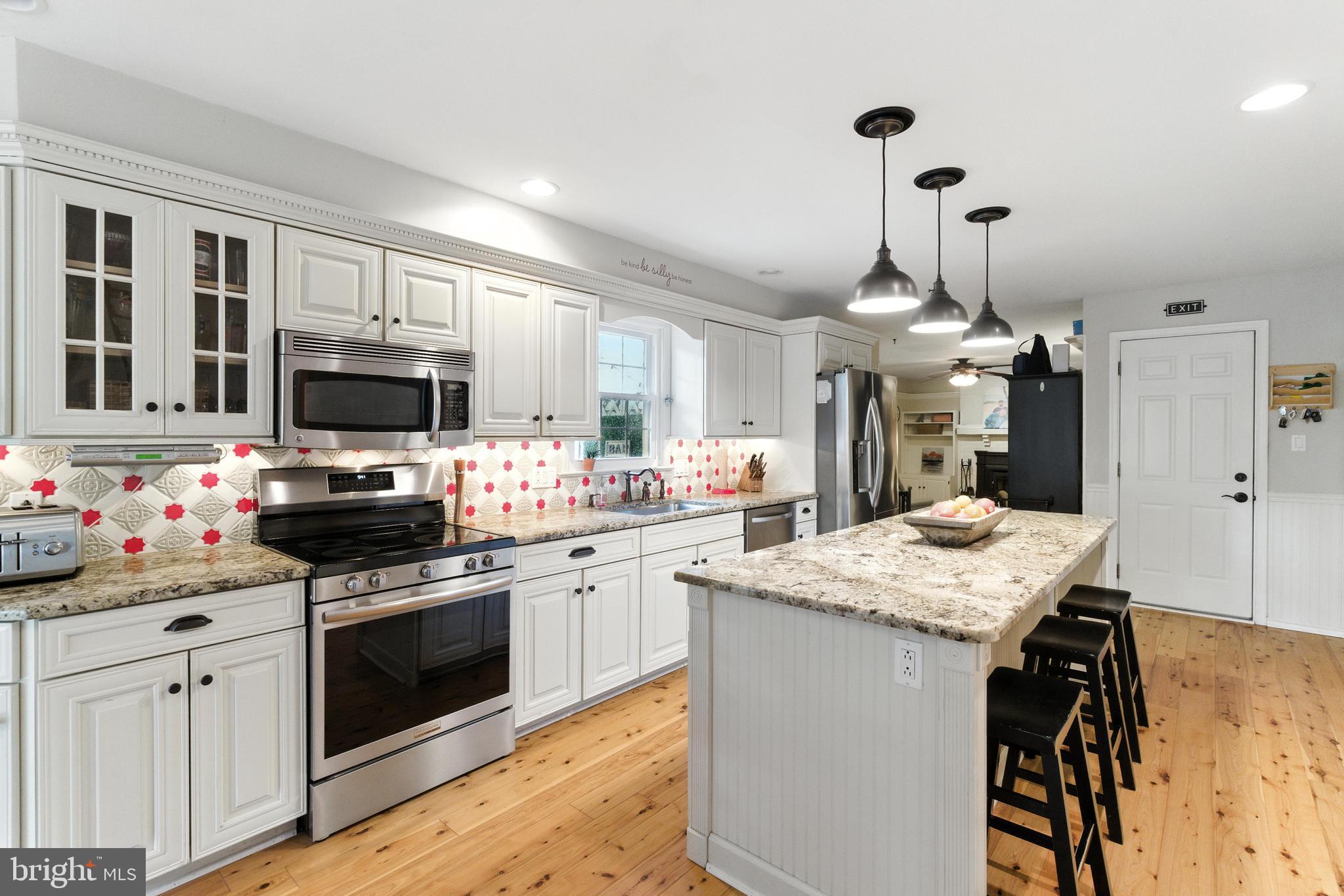 4 Robin Road Exton, PA 19341 - Photo 12 of 45 a kitchen with granite countertop a sink stainless steel appliances and white cabinets
