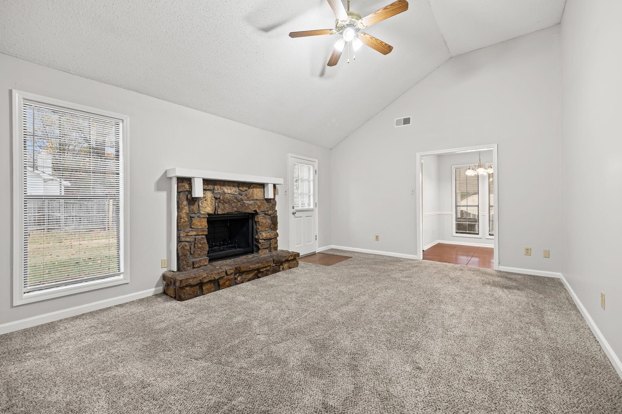 6730 Birch Run Lane Memphis, TN 38115 - Photo 5 of 20 a view of an empty room with a window and fireplace