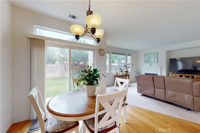 a view of a livingroom with wooden floor and a window