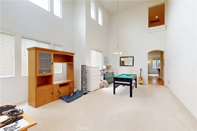 a room with pool table and windows