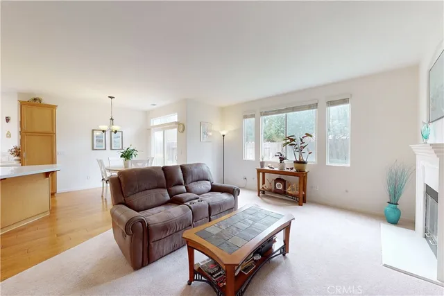 a living room with furniture and a dining table with projector