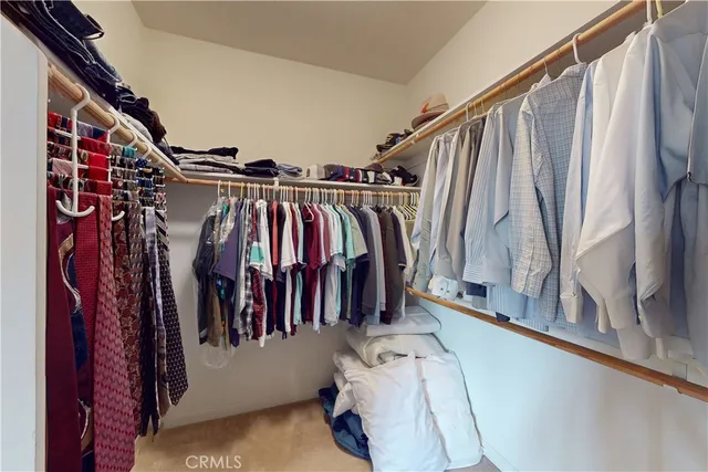 a bed room with a bed and a flat tv screen on a dresser