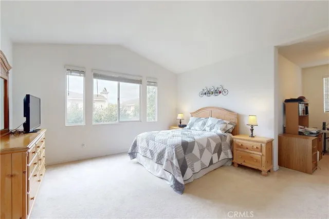 a bedroom with a large bed and a window