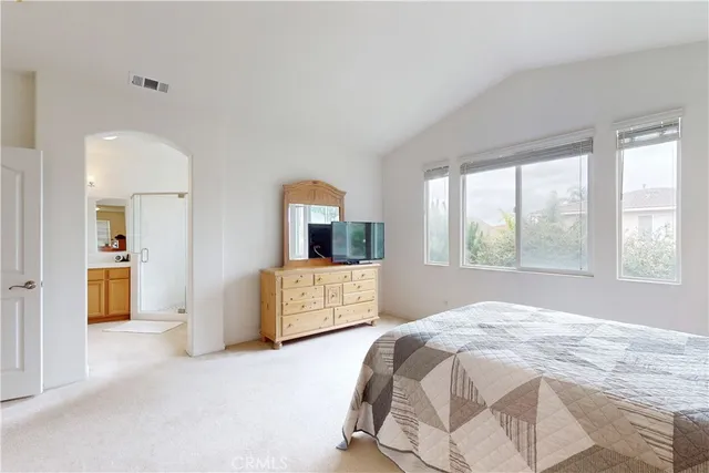a bed sitting in a bedroom next to a window