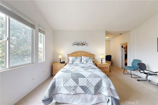 a bedroom with a bed and flat screen tv