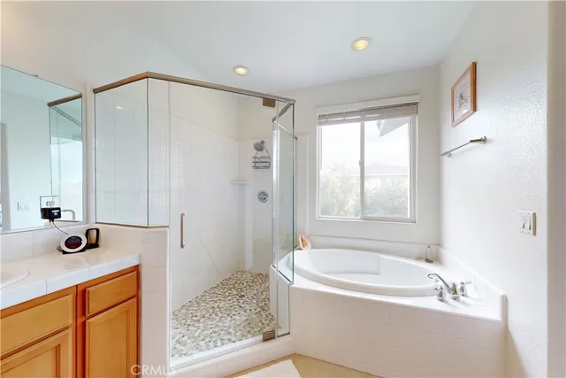 a spacious bathroom with a granite countertop sink mirror and a bath tub