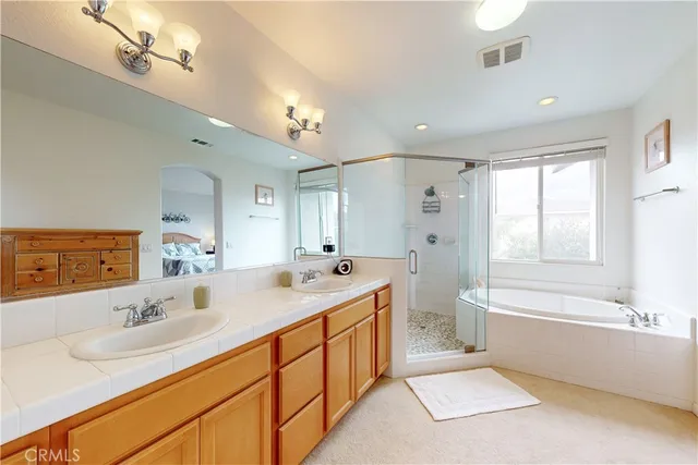 a bathroom with a double vanity sink and mirror