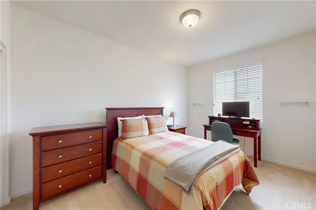 a bedroom with a bed and a night stand