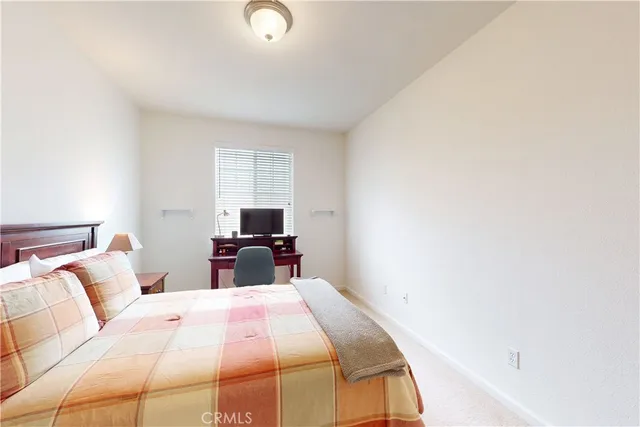 a bedroom with a bed and a night stand