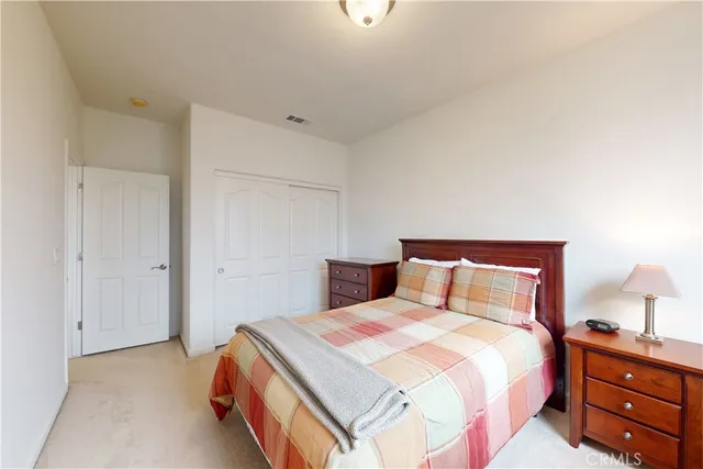 a bedroom with a bed and a painting on the wall