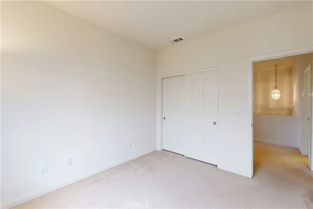 a view of empty room with ceiling fan